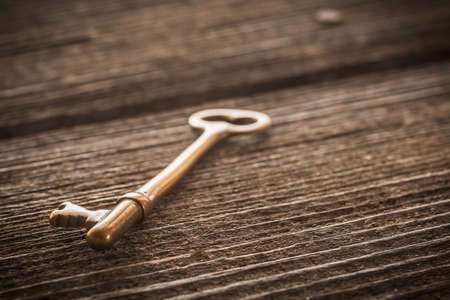 Old Brass Skeleton Key on Dark Rustic Barnwoodの写真素材
