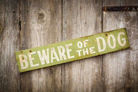 Beware Of Dog Sign on Old Worn Wood Fenceの写真素材