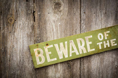 Beware Of Dog Sign on Old Worn Wood Fenceの写真素材
