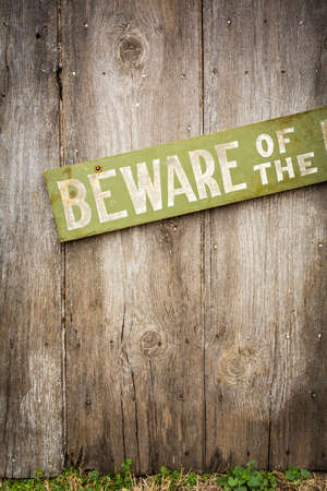 Beware Of Dog Sign on Old Worn Wood Fenceの写真素材