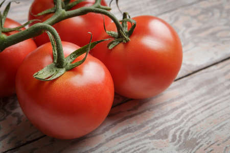 Fresh Tomatoes on Rustic Wooden Tableの写真素材