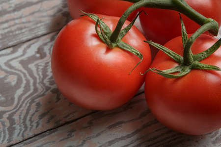 Fresh Tomatoes on Rustic Wooden Tableの写真素材