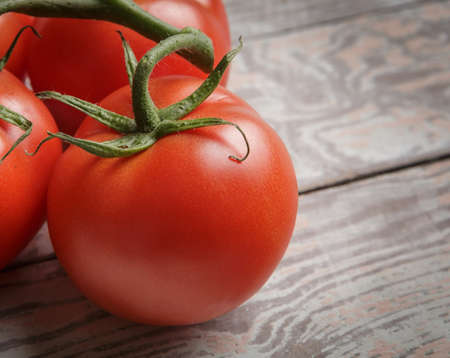 Fresh Tomatoes on Rustic Wooden Tableの写真素材