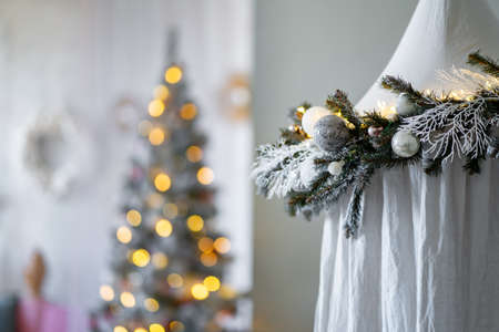 Festive living room with Christmas tree, decorated with spruce branches tentの写真素材
