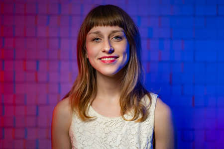Pretty young woman with blond hair with bangs. Concept of natural female beauty