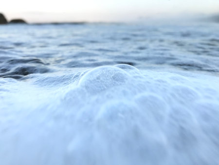 Sea wave on the beach in the evening. Shallow depth of field.の写真素材
