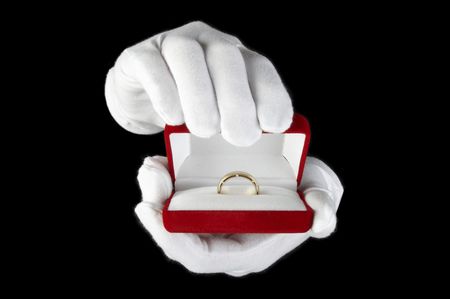hands in white gloves presented with an open box for jewelryの写真素材