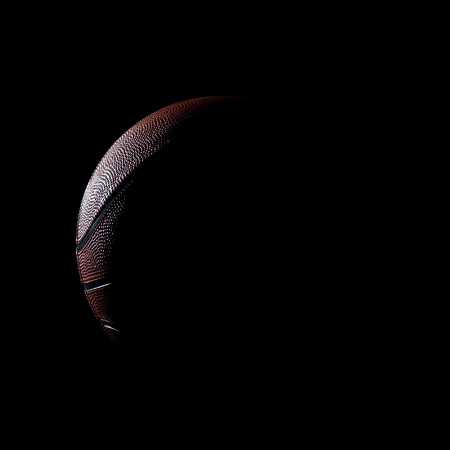 silhouette of a basketball against a black backgroundの写真素材