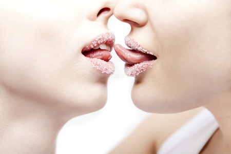 Closeup of pair girl lips and tongues with sugar powderの写真素材