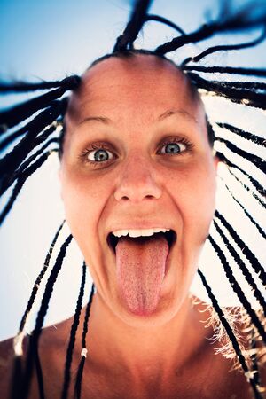 emotional portrait of young beautiful tanned girl with Pigtails