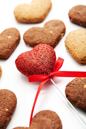 home baking cookies in the shape of heart, with a red heart in the center on a white backgroundの写真素材