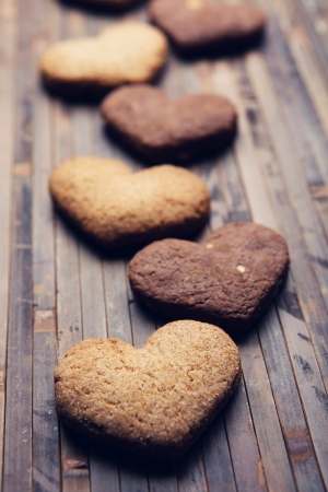 cookies in the shape of heart on a wooden backgroundの写真素材