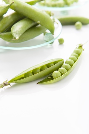 still life of fresh, ripe peas with peas on a white backgroundの写真素材