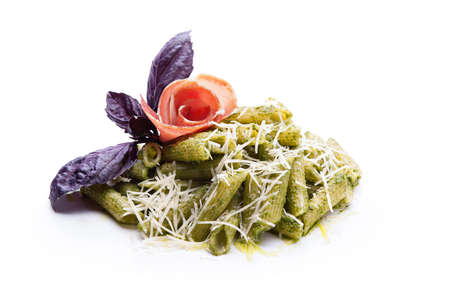 Typical italian pasta, rigatoni al pesto on white background の写真素材
