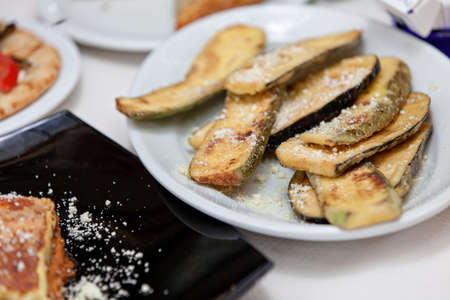 freshly fried zucchini sprinkled with parmesan cheeseの写真素材