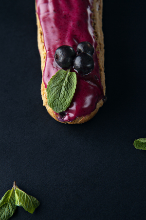 exquisite cream dessert eclair with blueberry and fresh mint leavesの写真素材