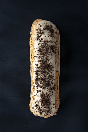 exquisite cream dessert eclair sprinkled with instant coffee