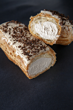 exquisite cream dessert eclair sprinkled with instant coffee