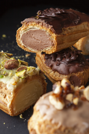 exquisite cream dessert eclair sprinkled with chocolate and pistachios