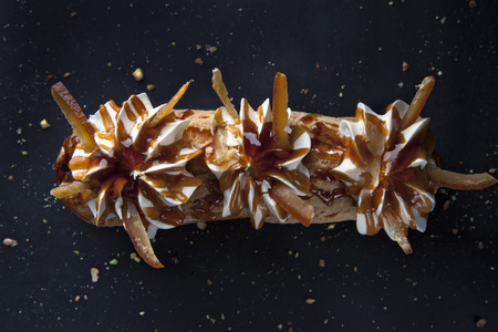 exquisite cream dessert eclair with candied fruit