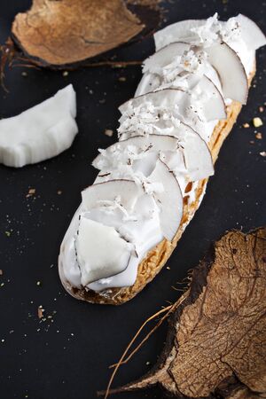 exquisite cream dessert eclair sprinkled with fresh coconut