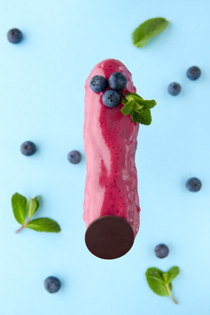 exquisite cream dessert eclair with blueberry and fresh mint leaves