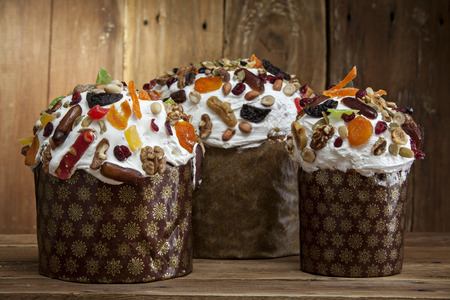 Three delicious freshly baked Easter cakes on a wooden background