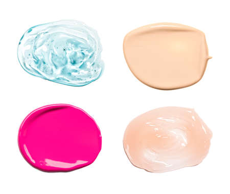 Collection of smear crushed cosmetic products on a white background