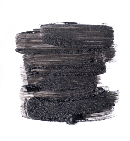 Black smear of cosmetic products on a white backgroundの写真素材