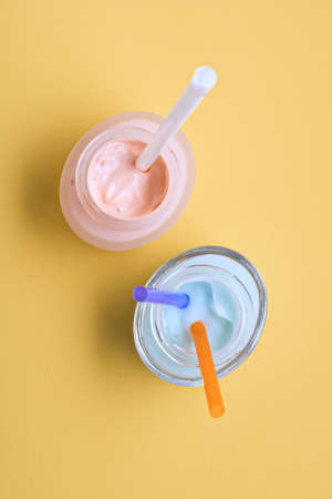 Concept of a nourishing cream for the face and body skin on a a yellow background