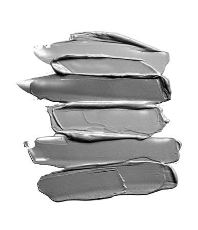 Collection of gray smear crushed cosmetic products on a white backgroundの写真素材