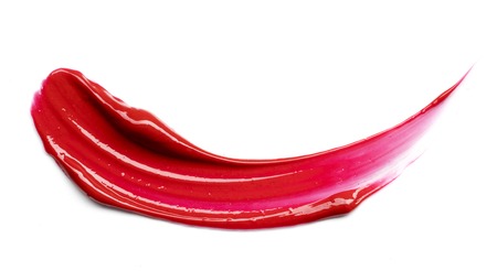 red smear paint of crushed lipstick on a white backgroundの写真素材
