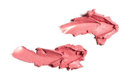 Collection of pink smear crushed cosmetic products on a white backgroundの写真素材