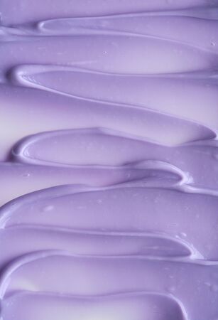 Purple makeup smear of lip gloss isolated on white background. Purple cream texture isolated on white backgroundの写真素材