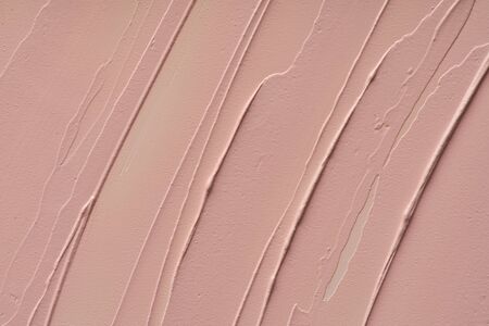 Pink makeup smear of creamy foundation isolated on white background. Pink creamy foundation texture...