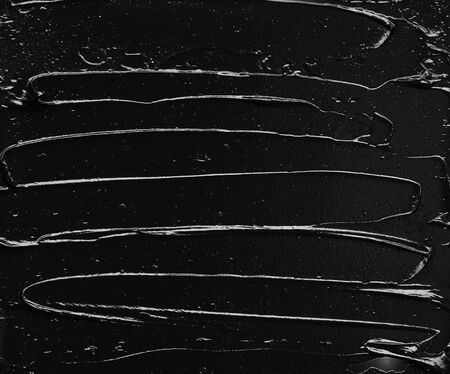 Texture of black crushed eyeliner or black acrylic paint isolated on white backgroundの写真素材