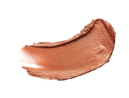 Bronze or gold texture of lip gloss or creamy eye shadow isolated on white backgroundの写真素材