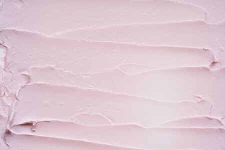 Gently pink brush strokes and texture of face cream or pink acrylic paint on a white backgroundの写真素材