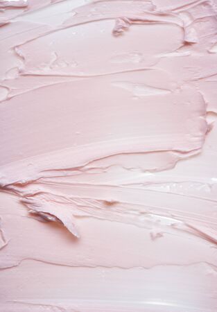 Gently pink brush strokes and texture of face cream or pink acrylic paint on a white backgroundの写真素材