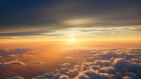 A stunning sunset sky with dramatic light and clouds below, viewed from an airplane cabin. The warm colors of the sky contrast with the cool blues of the clouds, creating a beautiful and serene atmosphere. Perfect for travel, vacation, and nature themes.の素材