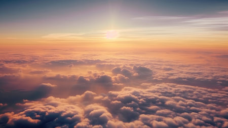 A stunning sunset sky with dramatic light and clouds below, viewed from an airplane cabin. The warm colors of the sky contrast with the cool blues of the clouds, creating a beautiful and serene atmosphere. Perfect for travel, vacation, and nature themes.の素材