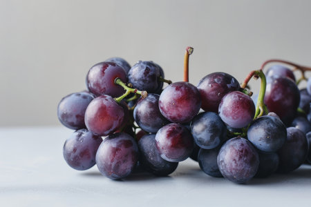 This image beautifully captures a bunch of ripe grapes in a realistic style, set against a white, flat-colored background. The front view highlights the grapes' lush color and natural texture, making it ideal for uses such as culinary publications, wine-related content, and health and wellness materialの素材