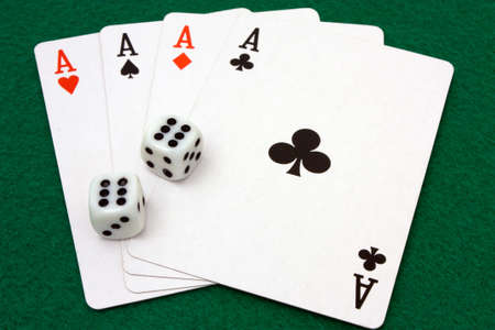 Card hand of four aces and dice rolled to double sixesの写真素材