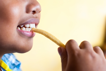 boy eating french friesの写真素材