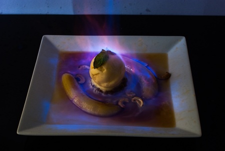 Banana flambe with ice cream and cashewsの写真素材