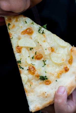 The Boy eating White Pizza