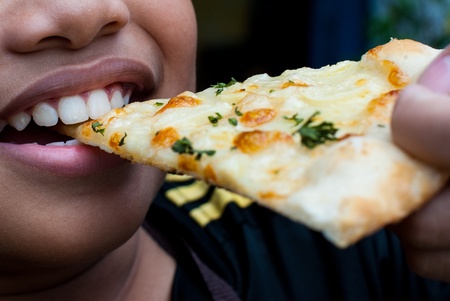 The Boy eating White Pizzaの写真素材