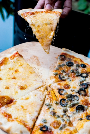 Napole pizza and Cheese pizza slice on  handの写真素材