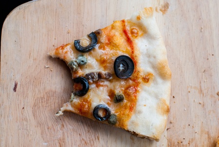 Napole pizza bite on wooden spatula