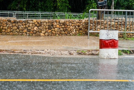 Stack of oil drums and raining on the roadの写真素材